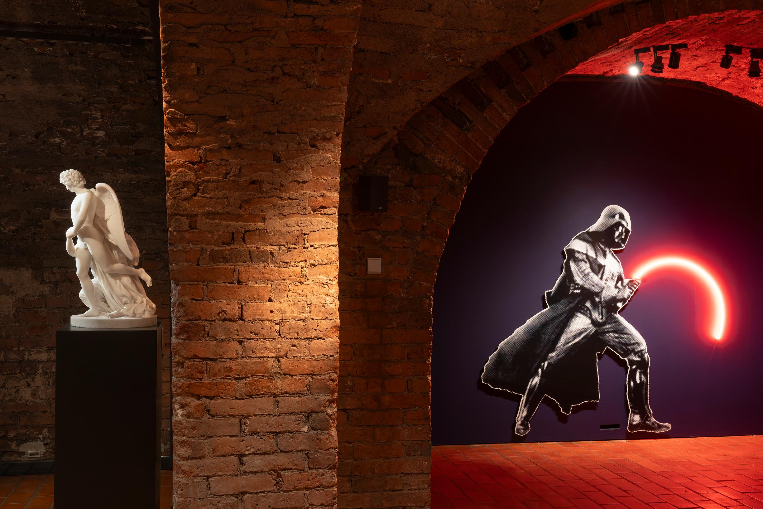 Kuva näyttelysalista, klassinen valkoinen patsas ja moderni teos, jossa Darth Vader