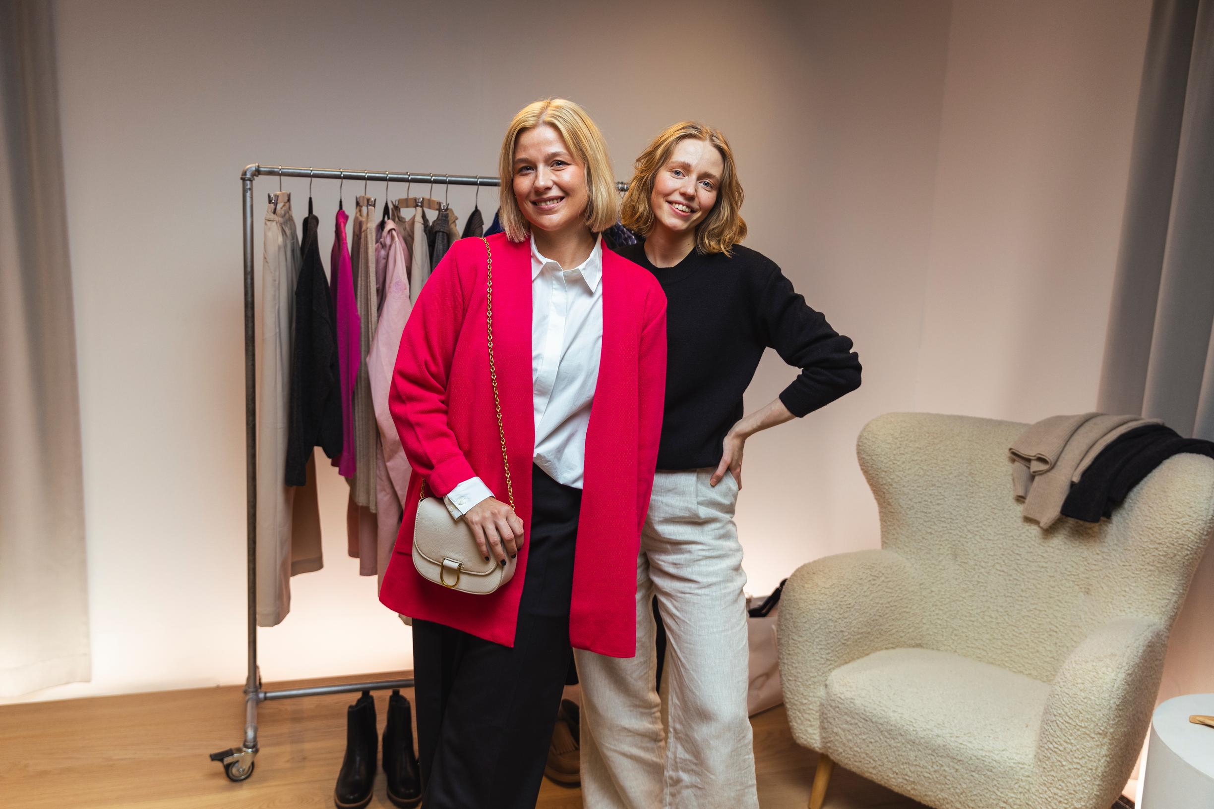 Tyylivalmentaja Elsa Hietanen (oik.) näyttää Irene-mallin päällä, miten valkoisen kauluspaidan voi pukea esimerkiksi neuletakin kanssa.